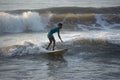 Kovalam, Chennai, Tamilnadu, India - Ã¢â¬Å½Ã¢â¬Å½August 9th Ã¢â¬Å½2021: Young boy Indian surfer surfing and practicing on the beach waves